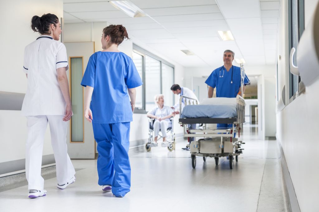 Nurse moving a hospital stretcher in hallway